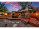 Outdoor deck featuring custom pergola, dining area, built-in grill, and cozy lighting at 1111 32Nd N St, St Petersburg, FL 33713