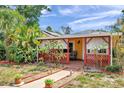 Charming home with inviting front porch, decorative lattice, and lush landscaping at 1111 32Nd N St, St Petersburg, FL 33713