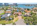 Aerial view of a waterfront home with a screened-in pool and tropical landscaping in a coastal community at 1141 80Th Street S Ct, St Petersburg, FL 33707