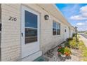 Inviting entryway of home featuring brick detail and lush landscaping at 12400 Park Blvd # 210, Seminole, FL 33772