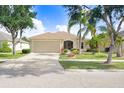 Single-story home with a well-kept lawn, established landscaping, and a convenient two-car garage for easy access at 13411 Graham Yarden Dr, Riverview, FL 33579
