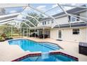 Screened-in pool with attached hot tub, dining, and lounge area offers a relaxing outdoor oasis at 1350 Mustang St, Nokomis, FL 34275