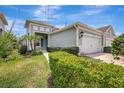 Attractive home with a well-kept lawn, vibrant plants, and convenient two-car garage at 13518 Circa Crossing Dr, Lithia, FL 33547
