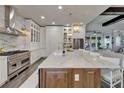 Gourmet kitchen featuring professional-grade appliances, a large center island, and pendant lighting at 14204 Barrington Stowers Dr, Lithia, FL 33547