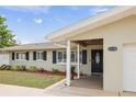 Welcoming front entrance with covered porch and landscaped garden beds at 14330 Oliver St, Largo, FL 33774