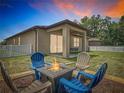 Inviting backyard featuring a cozy fire pit with seating, perfect for outdoor gatherings and relaxation at 15579 Stone House Dr, Brooksville, FL 34604