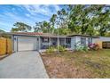 Charming single-story home with a cozy front porch and a well-maintained lawn at 15591 Darien Way, Clearwater, FL 33764