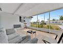 Relaxing screened-in porch with comfortable seating and views of the outdoors at 15591 Darien Way, Clearwater, FL 33764