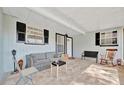 Cozy covered porch with brick floors, charming furniture, and natural light at 15591 Darien Way, Clearwater, FL 33764