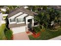 Attractive two-story home featuring well-maintained landscaping and a brick driveway, offering classic curb appeal at 19314 Long Lake Ranch Blvd, Lutz, FL 33558