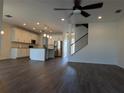Open-concept living space boasts a modern kitchen, wood floors, and ample natural light at 19314 Long Lake Ranch Blvd, Lutz, FL 33558