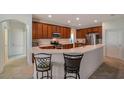 Open kitchen with stainless steel appliances, breakfast bar, and tile flooring at 2218 Valterra Vista Way, Valrico, FL 33594
