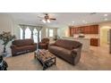 Comfortable living room with a ceiling fan, open to kitchen, and ample seating for relaxation at 2218 Valterra Vista Way, Valrico, FL 33594