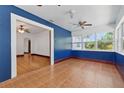 Bright and sunny sun room with a blue accent wall, neutral tiling, and multiple large windows at 2710 8Th N Ave, St Petersburg, FL 33713