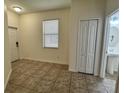 Open entryway featuring neutral colored tile flooring and a half bathroom at 2731 Hampton Green Ln, Brandon, FL 33511