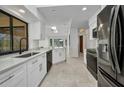 Modern kitchen featuring stainless steel appliances, quartz countertops, and tile flooring at 280 Fortaleza St, Punta Gorda, FL 33983
