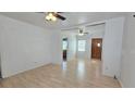 Open-concept living room featuring laminate floors and neutral walls, awaiting personal touches at 342 N 40Th N St, St Petersburg, FL 33713