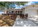 Charming single-story home with a brick facade, lush landscaping, and a welcoming front entrance, perfect for suburban living at 3537 12Th N Ave, St Petersburg, FL 33713