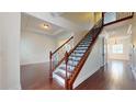 Elegant staircase with wood and iron detailing, complemented by hardwood flooring throughout at 3615 S Church Ave, Tampa, FL 33629