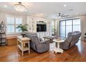 Bright living room with hardwood floors, a chandelier, and a built-in entertainment center at 4689 Wandering Way, Wesley Chapel, FL 33544