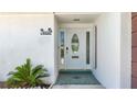 Elegant front entrance features a decorative glass door and tiled entryway at 4920 Pelican Dr, New Port Richey, FL 34652