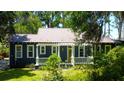 Charming home exterior features a cozy front porch and well-maintained landscaping at 6341 Discovery Ln, Land O Lakes, FL 34638