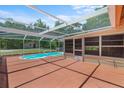 Enclosed patio area with a private pool, perfect for outdoor relaxation and entertaining at 7095 South St, Webster, FL 33597