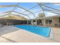 Enclosed pool area featuring a spacious pool with ample lounging space and clear overhead coverage at 7325 Calder Dr, New Port Richey, FL 34653
