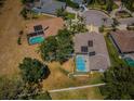 Aerial view of home with screened in pool and solar panels on roof in a cul-de-sac at 8926 Garner Ct, Trinity, FL 34655