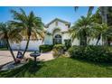 Charming single-story home with a well-manicured lawn, palm trees, and a two-car garage at 8926 Garner Ct, Trinity, FL 34655