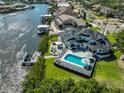 Waterfront home featuring an inviting backyard pool, patio area, and private dock at 945 Bunker View Dr, Apollo Beach, FL 33572