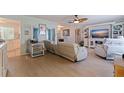 Bright living room featuring hardwood floors, a ceiling fan, and modern neutral-toned furniture at 9511 45Th N St # 9511, Pinellas Park, FL 33782