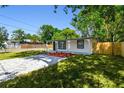 Cozy home with freshly painted exterior, manicured lawn, modern stone driveway, and a new fence at 10011 N Annette Ave, Tampa, FL 33612