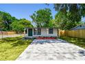 Charming single-story home with new landscaping, a freshly painted exterior, and a modern stone driveway at 10011 N Annette Ave, Tampa, FL 33612