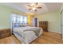 Bright bedroom with a tray ceiling, wooden floors, and a cozy ambiance at 11311 Corey Pavin Ln, San Antonio, FL 33576