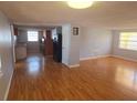 Inviting living room with hardwood floors and a view into the kitchen at 11625 Constance Dr, Port Richey, FL 34668