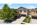 Two-story home featuring stone accents, well-manicured lawn, mature landscaping and an attached two car garage at 11760 Winterset Cove Dr, Riverview, FL 33579