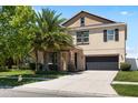 Two-story home featuring stone accents, well-manicured lawn, mature landscaping and an attached two car garage at 11760 Winterset Cove Dr, Riverview, FL 33579