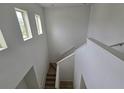Bright, open staircase featuring modern design, white walls and trim, and natural light at 11839 Cross Vine Dr, Riverview, FL 33579