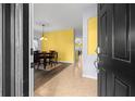 Open entryway featuring tile flooring, a dining area, and views into the home at 12008 Fern Blossom Dr, Gibsonton, FL 33534