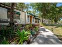 Charming single-story home featuring well-kept landscaping, cozy porch and walkway at 1211 E Park Cir, Tampa, FL 33604