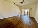 Spacious living room features hardwood floors, high ceilings, and sliding glass doors to the patio at 1604 Wakefield Dr, Brandon, FL 33511