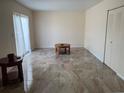 Open floor plan of living room featuring tile flooring, white walls, and a sliding glass door at 1799 N Highland Ave # 170, Clearwater, FL 33755