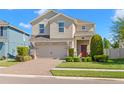 Inviting two-story home with a well-manicured lawn and a brick-paved driveway at 19487 Roseate Dr, Lutz, FL 33558