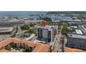 Aerial view of condo complex with a rooftop pool and marina nearby at 199 Dali Blvd # 902, St Petersburg, FL 33701