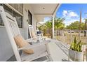 Inviting front porch with rocking chairs and decorative plants, perfect for relaxing outdoors at 212 N Bradford Ave, Tampa, FL 33609