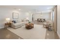 Bright, open-concept living and dining area with contemporary furnishings and neutral color palette at 2904 W Marlin Ave, Tampa, FL 33611
