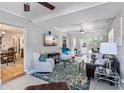 Open-concept living room with a ceiling fan, recessed lighting, comfortable seating, and bright natural light at 3005 W Helen Ave, Tampa, FL 33611