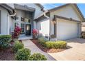 Inviting front entrance with lush landscaping and a paved walkway to the front door at 3023 Bent Creek Dr, Valrico, FL 33596