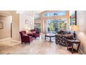 Open-concept living room featuring travertine floors and lots of natural light at 3023 Bent Creek Dr, Valrico, FL 33596